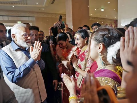 Modi receives a warm welcome by saree-clad Egyptian women and members of Indian diaspora upon his arrival at a hotel in Cairo on Saturday. 