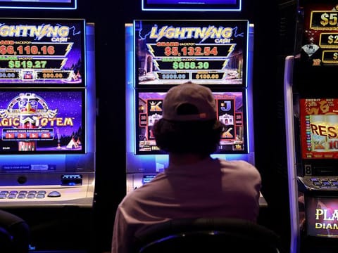 A person gambles on a poker machine at a pub in Sydney, Australia, September 19, 2022.   