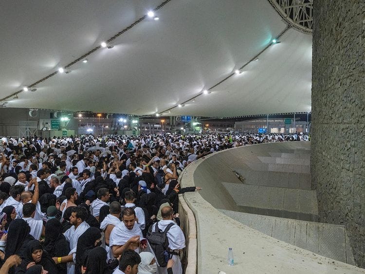 Pilgrims cast their stones at a pillar symbolising the stoning of Satan in Mina on June 28, 2023.  