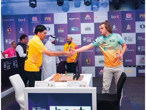  Vishwanathan Anand congratulates Magnus Carlsen with after their game in the Global Chess League on Wednesday.