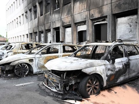 Seven burnt out vehicles are seen outside the municipal police building following violence in Neuilly-sur-Marne on June 29, 2023, a day after the killing of a 17-year-old boy in Nanterre, west of Paris, by a police officer's gunshot following a refusal to comply.  