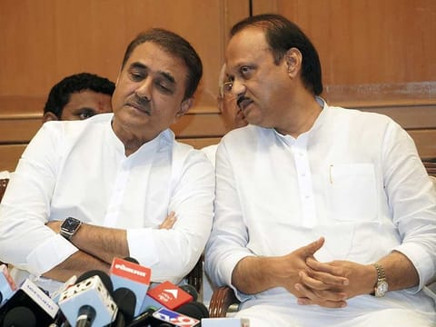 Maharashtra Deputy Chief Minister Ajit Pawar in a conversation with Nationalist Congress Party (NCP) leader Praful Patel during a press conference, at Sahyadri State Guest House, in Mumbai on Monday, July 3, 2023. 