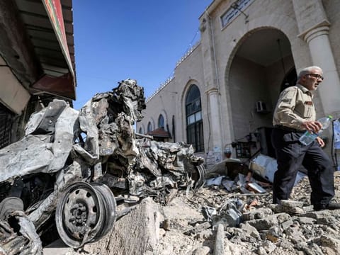 The rubble and remains of a destroyed vehicle outside a mosque in the West Bank city of Jenin on July 5, 2023, after the Israeli army declared the end of a two-day military operation in the area.  