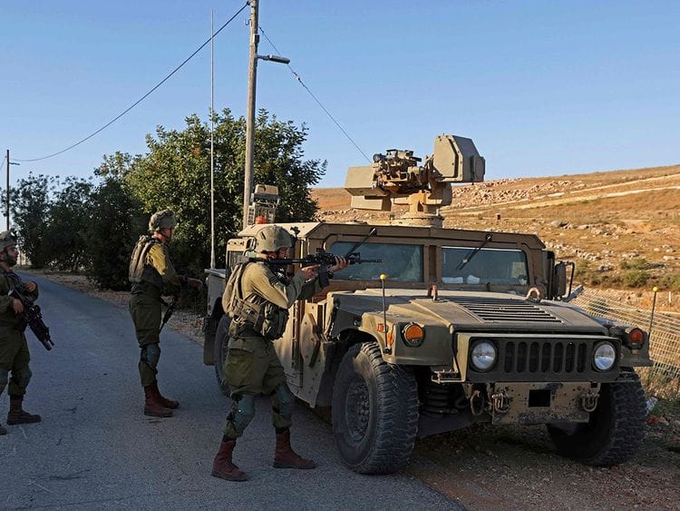 Israeli soldiers take position along border with Lebanon, in the town of Metulla in northern Israel on July 12, 2023.  