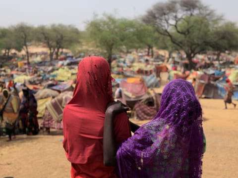 Sudanese girls who fled the conflict in Sudan's Darfur region, and were previously internally displaced in Sudan, look at makeshift shelters near the border between Sudan and Chad, while taking refuge in Borota, Chad May 13, 2023.  