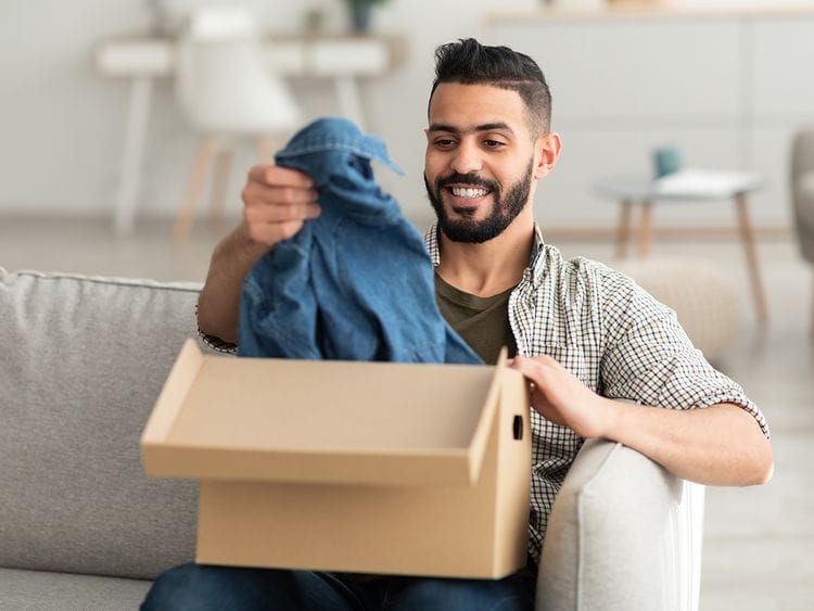 Person opening new box of clothes