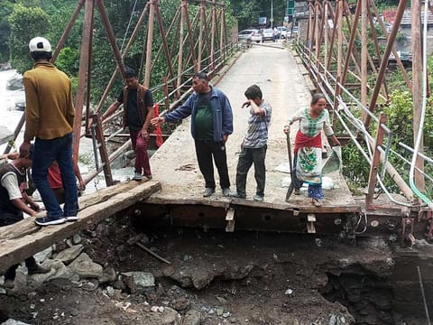 A portion of a bridge that was damaged near the Tirthan river after torrential rains, in Kullu on Sunday, July 16, 2023. 
