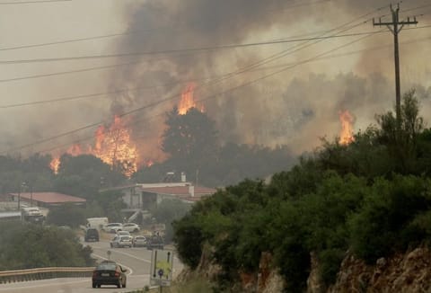 A wildfire burns near the village of Agios Sotira, west of Athens, Greece, July 20, 2023.  