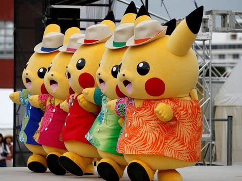 Performers in Pikachu costumes dance at a Splash show and Pokemon Go Park event in Yokohama, Japan.