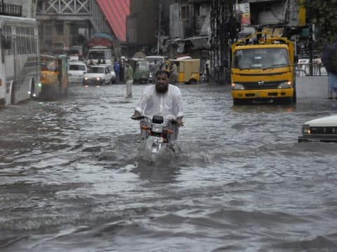 A man cries outside the mortuary after he lost his son by monsoon rains on the outskirts of Islamabad, on July 19, 2023. 