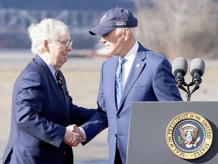 US President Joe Biden shakes hands with US Senate Republican Leader Mitch McConnell. 