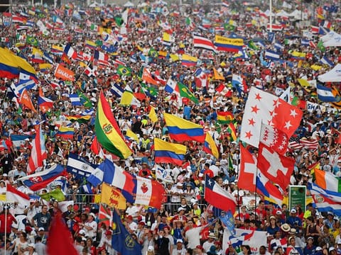 Pilgrims cheer and wave flags as Pope Francis arrives to preside over an evening vigil with young people at the Campo San Juan Pablo II in Panama City, on January 26, 2019