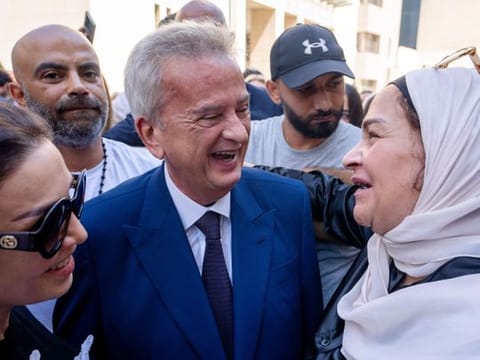Riad Salameh (centre), Lebanon's outgoing Central Bank governor, greets employees at a farewell ceremony marking the end of his 30 years in office outside the Central Bank building in Beirut on July 31, 2023. Many solely blame him for the collapse of the banking sector, which sent thousands of people into financial ruin and bankruptcy. 