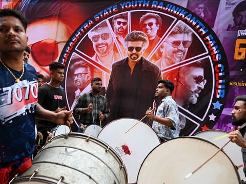 Fans play drums before the screening of Indian actor Rajinikanth's new Tamil-language movie 'Jailer' on the first day of its release, outside a theatre in Mumbai on August 10, 2023
