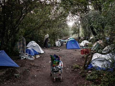 This photograph taken on August 12, 2023, shows tents of migrants installed at a makeshift camp in Loon-Plage, northern France. Six people have been killed as a boat carrying migrants heading to Britain sank in the Channel. Five French ships and a helicopter, as well as two British vessels, were involved in a rescue operation while some passengers were still missing, and about 50 migrants were rescued, some of them by the British vessels, the authorities said.  