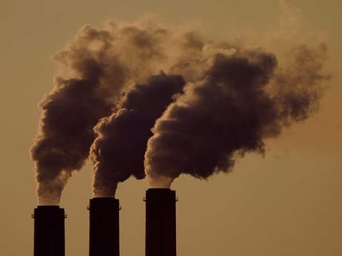 Emissions rise from the smokestacks at the Jeffrey Energy Center coal power plant as the suns sets, near Emmett, Kan., Sept. 18, 2021. 