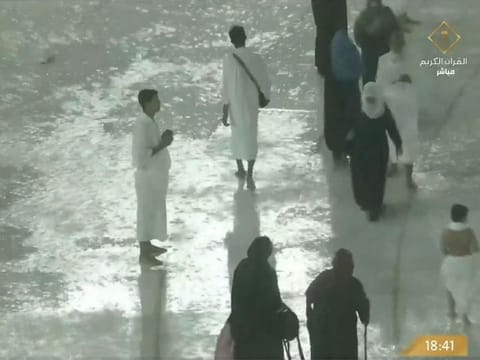 Video screengrab of Umrah pilgrims praying amid heavy rains and thunderstorms in Mecca
