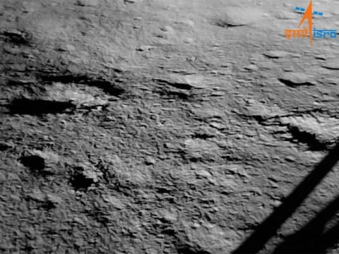 The surface of the moon can be seen beside the leg of a lunar lander The first image of the moon's surface taken by India's Chandrayaan-3 mission after its historic touchdown on Aug. 23, 2023.
