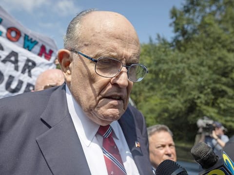 Former New York City Mayor and attorney of former US President Donald Trump, Rudy Giuliani, speaks to members of the media after being booked, outside the Fulton County Jail in Atlanta, Georgia, on August 23, 2023.  