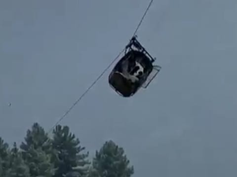 A cable car carrying six children and two adults dangles hundreds of metres above the ground in the remote Battagram district, Khyber Pakhtunkhwa, Pakistan on  August 22, 2023.  
