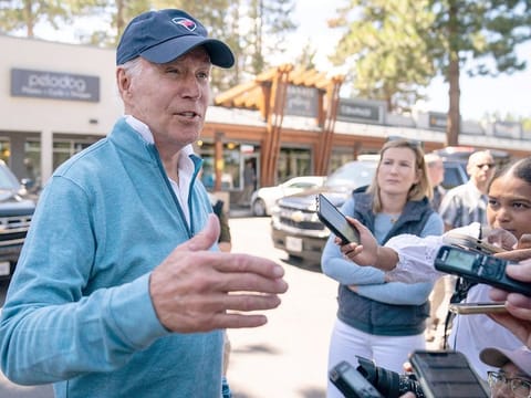 US President Joe Biden talks with reporters after taking a Pilates and spin class at PeloDog, on Friday, in South Lake Tahoe, California. 