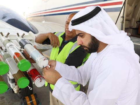An NCM researcher makes final checks on a cloud seeding flare on a plane for the new project