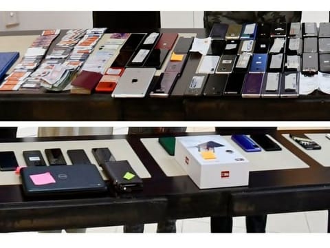 Cash, smartphones, digital tablets, banks cards, notes and other items siezed by UAE police from the suspected electronic fraudsters.