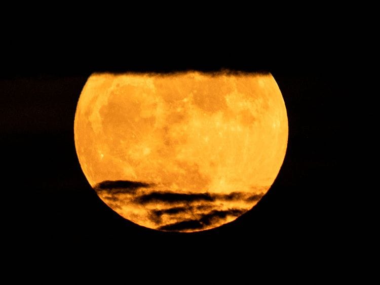 The "Blue Supermoon", the second full moon of a calendar month, rises over Havana on August 30, 2023. (Photo by YAMIL LAGE / AFP)