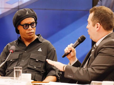 Ronaldinho (L) attends a session of the Parliamentary Commission of Inquiry to give his testimony on cryptocurrencies at the Chamber of Deputies in Brasilia, on August 31, 2023. 