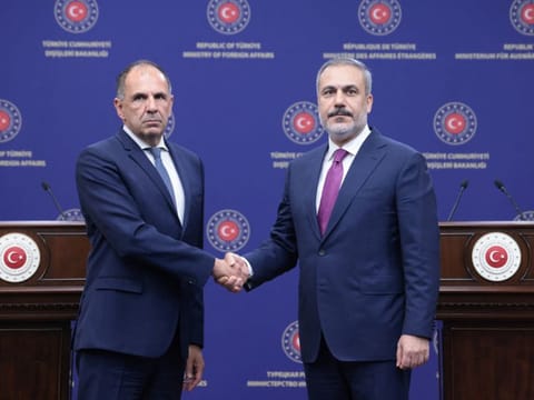 Turkish Foreign Minister Hakan Fidan shakes hands with his Greek counterpart George Gerapetritis during a press conference in Ankara on September 5, 2023. 