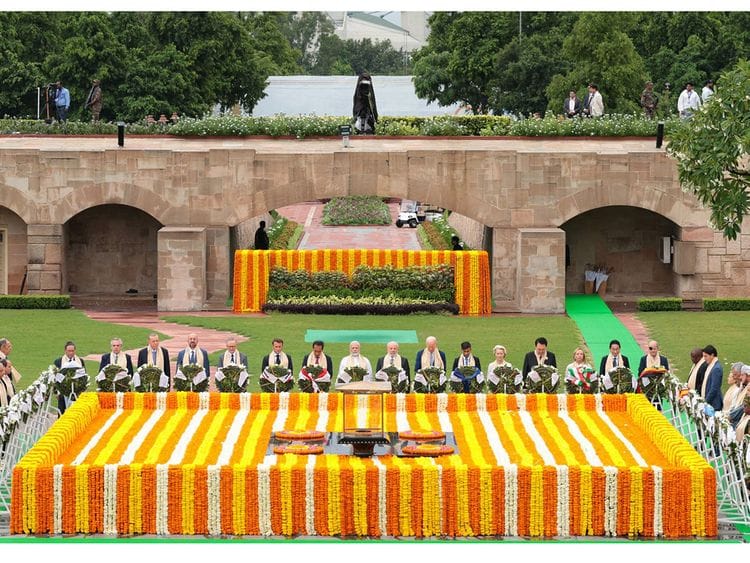 India's Prime Minister Narendra Modi (centre) along with world leaders pays respect at the Mahatma Gandhi memorial at Raj Ghat on the sidelines of the G20 summit in New Delhi on September 10, 2023.  