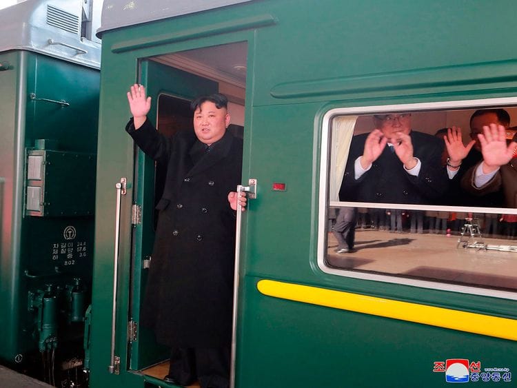 North Korean leader Kim Jong Un waves from a train before leaving Pyongyang Station, North Korea, for Vietnam, on February 23, 2019.  