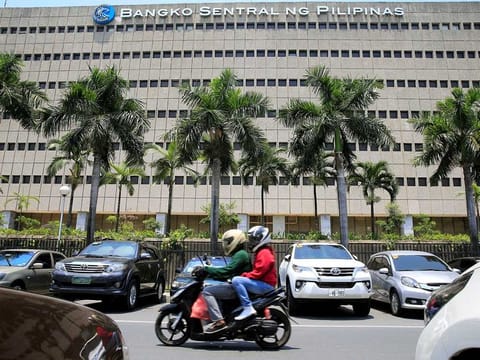 A motorcycle pases a building of the Bangko Sentral ng Pilipinas (Central Bank of the Philippines) in Manila, Philippines REUTERS