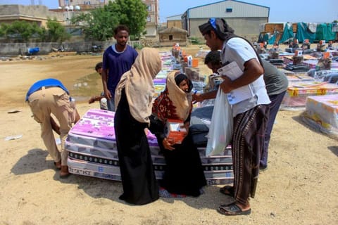  Displaced Yemenis receive essential aid provided by the Norwegian Council to support those affected by flooding, in the northern Abs district of the Hajjah governorate on September 16, 2023.  