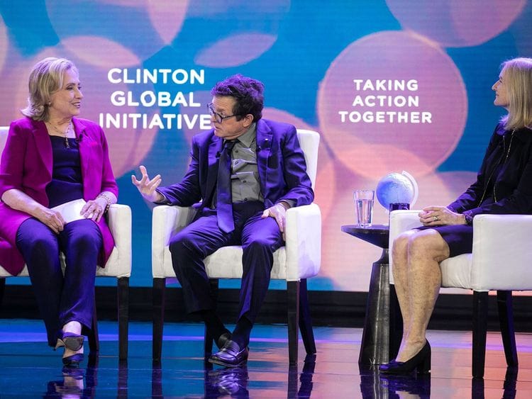 Hollywood actor Michael J Fox speaks with former US Secretary of State Hillary Clinton.