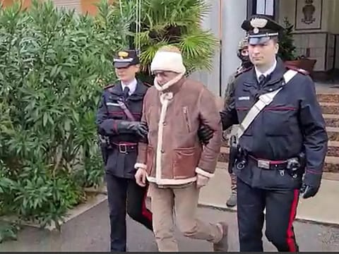 Italy's top wanted mafia boss, Matteo Messina Denaro (centre) being transferred from the Carabinieri police station of San Lorenzo in Palermo, to an undisclosed location, following his arrest in his native Sicily on January 16, 2023. 