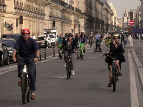 People ride on Rivoli street in Paris, Wednesday, Sept. 13, 2023. 