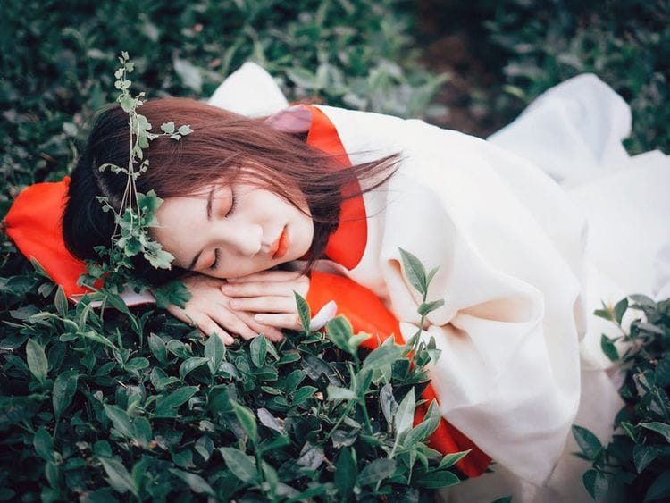 Woman sleeping on leaves