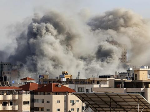 Smoke plumes rise over Gaza City on October 7, 2023 during Israeli air strikes. Palestinian militants have begun a "war" against Israel, the country's defence minister said on October 7 after a barrage of rockets were fired and fighters from the Palestinian enclave infiltrated Israel.  