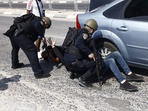 Israeli police check the occupants of a vehicle near Ashkelon, Israel, on October 8, 2023. Fighting continued in southern Israel for a second day as Israeli Defence Forces sought to regain control of areas infiltrated yesterday by militants from the Gaza Strip.  