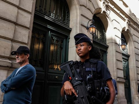 A French police officer carrying a G36 assault rifle patrols outside the Tournelles Synagogue, after increased security measures were put in place at Jewish temples and schools, in central Paris, on October 8, 2023.  