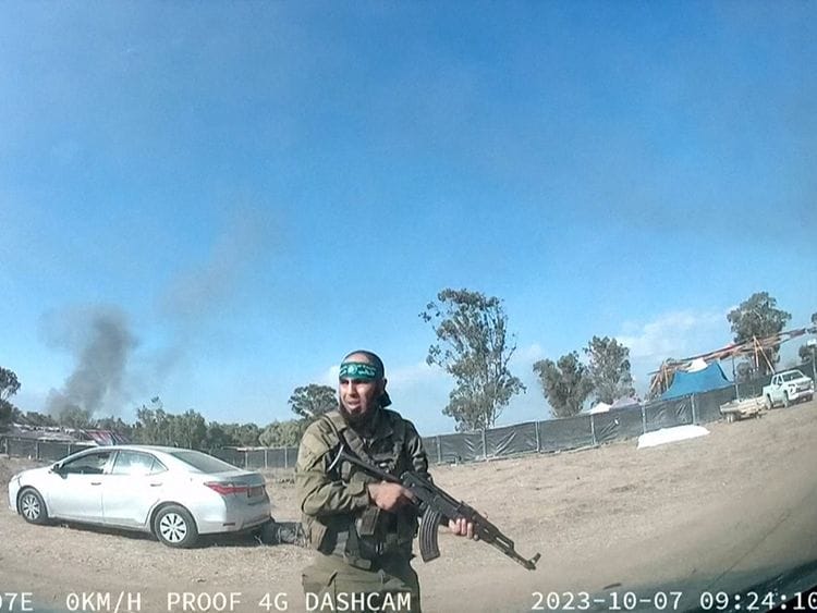 A grab from a UGC video posted on Telegram on October 9, 2023, shows a Palestinian militant walking around the Supernova music festival, near Kibbutz Reim in the Negev desert in southern Israel.