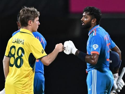 Australian spinner Adam Zampa congratulates Hardik Pandya (right) after India won the World Cup match in Chennai on Sunday.