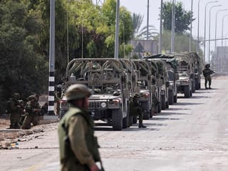 Photos: Israel builds forces near Gaza as it mourns dead