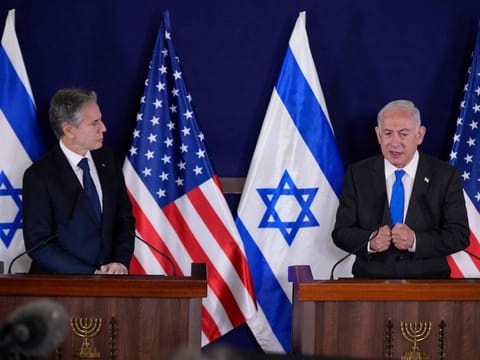 US Secretary of State Antony Blinken (left) and Israel's Prime Minister Benjamin Netanyahu give statements to the media inside The Kirya, which houses the Israeli Defence Ministry, after their meeting in Tel Aviv on October 12, 2023.  