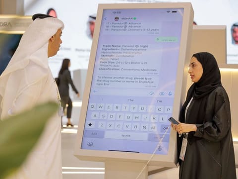A Ministry of Health and Prevention official (right) explains the service to a visitor at Gitex tech show in Dubai