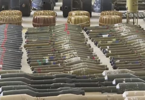 Suspected North Korean-made F-7 rocket-propelled grenades, many with a distinctive red stripe on their warhead, are seen at an Israeli military base in southern Israel, on October 15, 2023.  