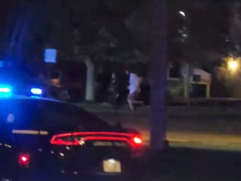 People run from the scene of a mass shooting in Lewiston, Maine.
