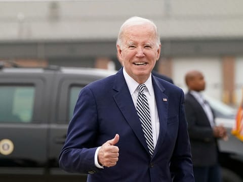 US President Joe Biden gestures as he walks to board Air Force One on return travel to Washington, from Delaware Air National Guard Base in New Castle, Delaware, U.S., October 30, 2023.