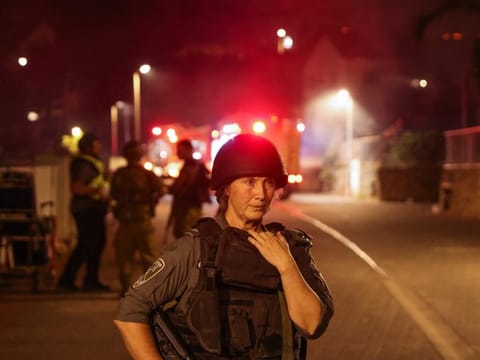 Israeli security forces and emergency services arrive as smoke rises from a house in the northern city of Kiryat Shmona after being reportedly hit by a rocket from Lebanon on October 29, 2023, amid increasing cross-border tensions.  